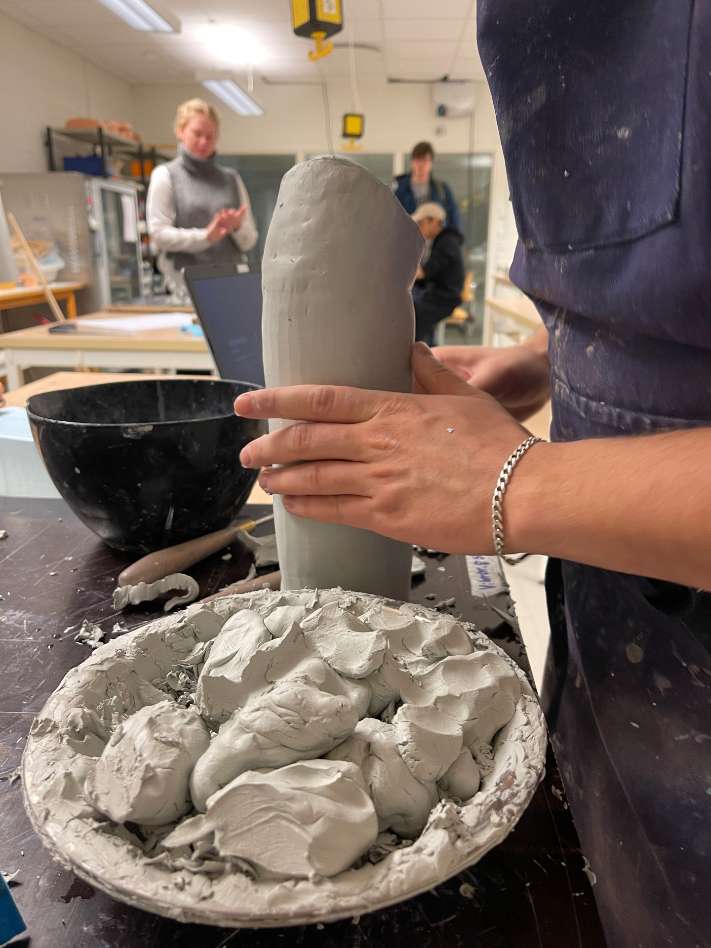 Shaping the clay prototype in the workshop.