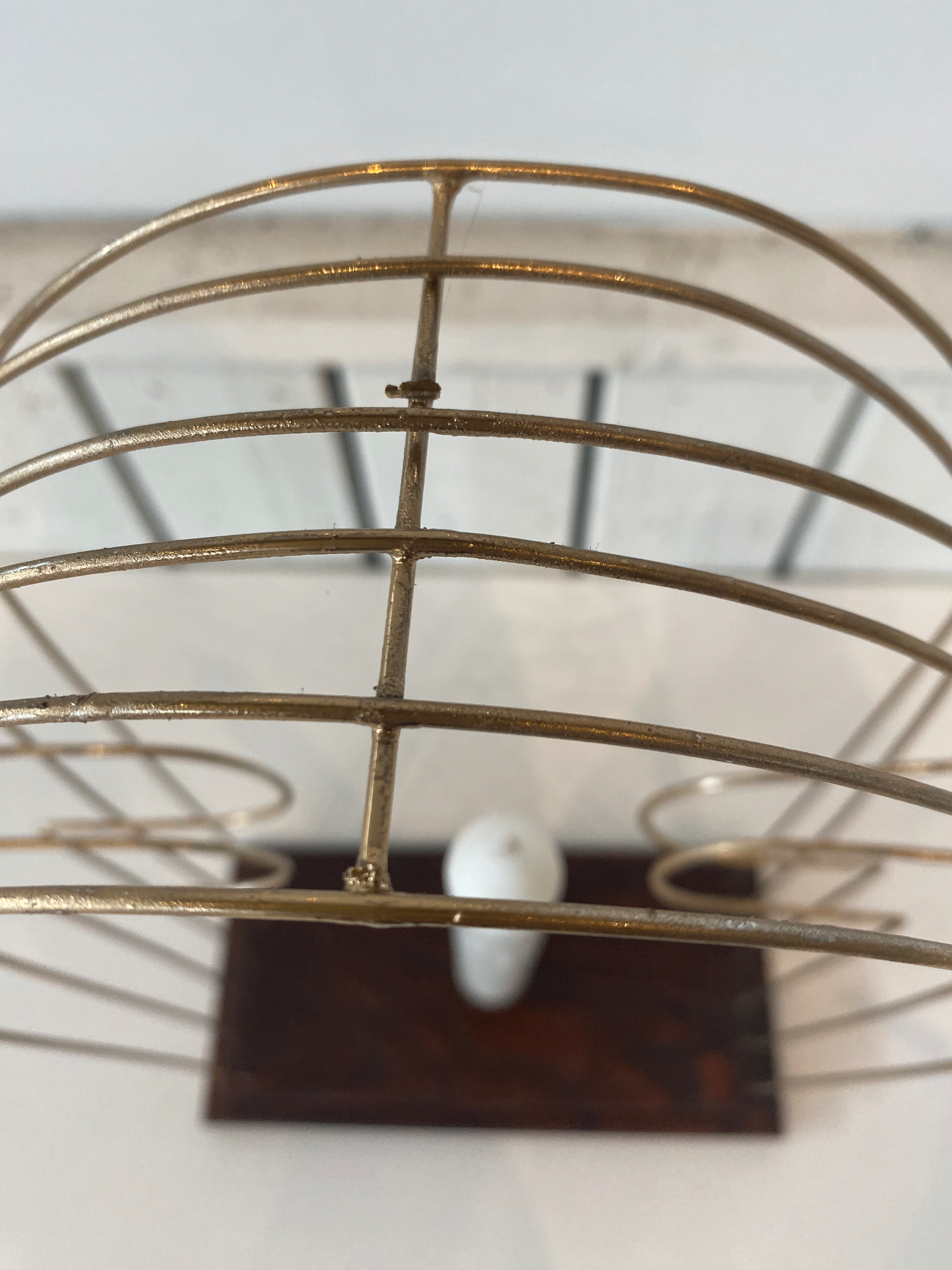 Close up view from above showing the curved metal rods and their spacing where they meet at the top of the frame.
